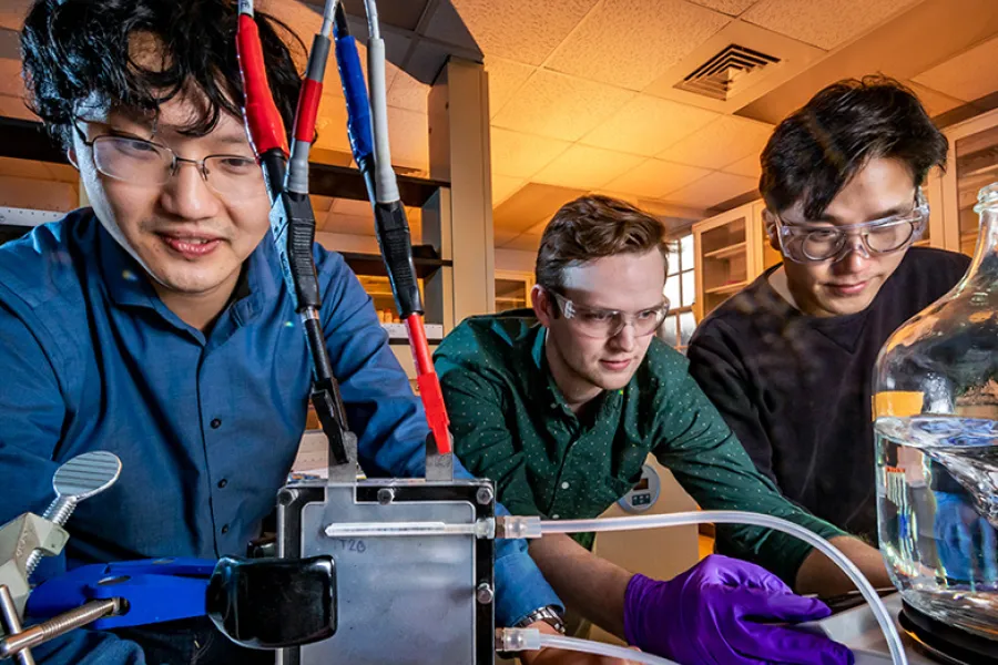 Professor Xiao Su, left, graduate student Stephen Cotty, center, and postdoctoral researcher Kwiyong Kim have developed an energy-efficient device that selectively absorbs a highly toxic form of arsenic in water and converts it into a far less toxic form. 