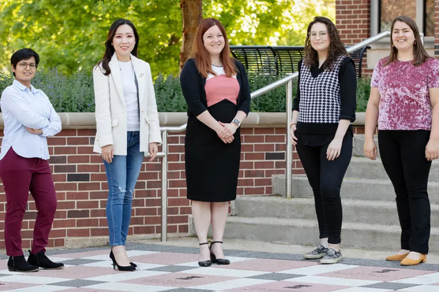 Five authors of the research stand next to each other. 