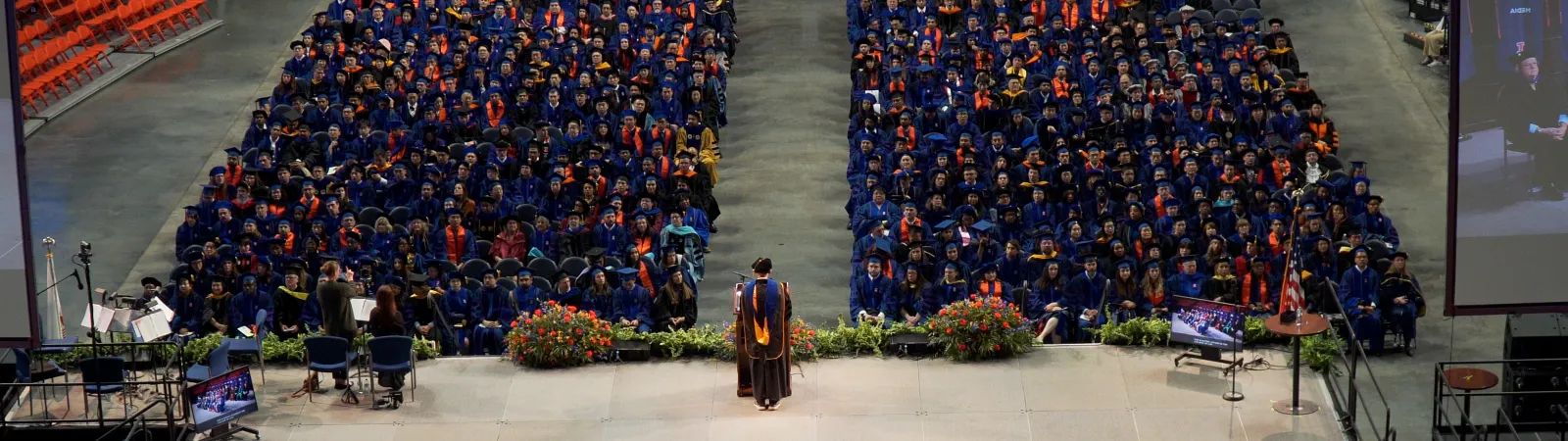 The stage and graduates at the doctoral hooding