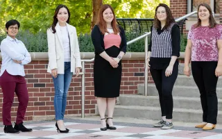 Five authors of the research stand next to each other. 