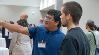 students looking at research poster