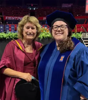 Katie Moore and Mary Kalantzis at the doctoral hooding ceremony