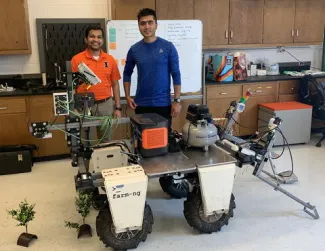 Sunoj Shajahan and Sandesh Poudel with the robotic weeder.